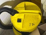a yellow vacuum cleaner sitting on the floor next to a cardboard box