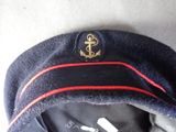 a blue hat with a gold anchor on it
