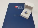 a close up of a brochure with a ring inside of it