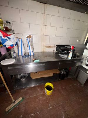 an image of a kitchen with a lot of clutter on the floor