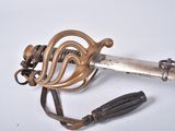 an old sword with a metal handle and a leather strap