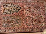 a rug on the floor next to a bed