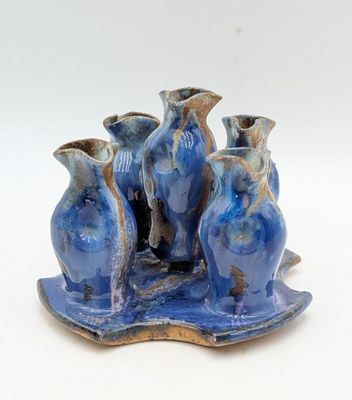 three vases that are sitting on a tray