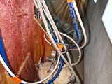 a blue hose attached to a wall in a room