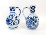 two blue and white vases sitting next to each other