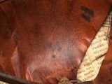 a close up of a pair of scissors on a leather bag