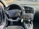 the interior of a car with a steering wheel and dashboard controls