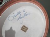a close up of a vase with writing on it