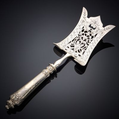 an antique silverware knife with ornate design on a black background