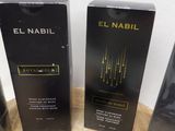 two boxes of perfume sitting on top of a table next to each other