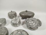 a lot of silver objects on a white surface