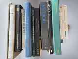 a lot of books that are on a shelf
