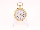 a gold pocket watch with roman numerals on the face