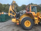 a picture of a yellow construction vehicle parked in a lot