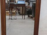 a mirror that is sitting on the ground in front of a wall