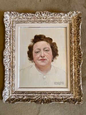 Une peinture à l'huile représentant une femme en robe blanche est accrochée au mur.