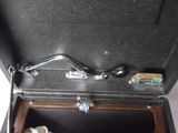 a black suitcase with a metal handle and a key in it