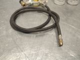 a hose that is sitting on a table next to some paint