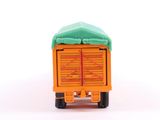 a small toy truck with a green roof on a white surface