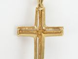 a gold cross pendant on a white background