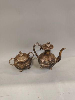 a pair of antique brass teapots with lids