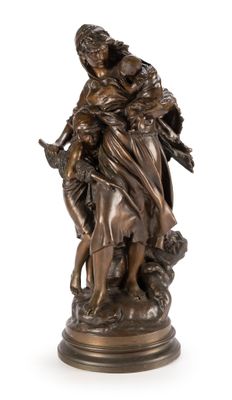 a bronze statue of a woman holding a child on a rock