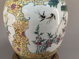 an image of a vase with a bird and flowers on it