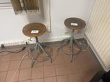 two stools sitting next to each other on a tiled floor