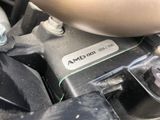 a close up of a car engine with a button on it
