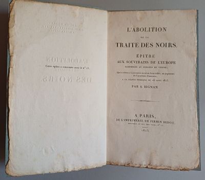 an old book opened to show the title of a novel