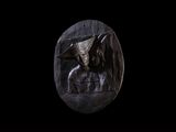statue of a man with a bat on his head on a black background