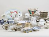 many different types of dishes and cups on the table