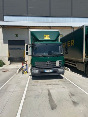 two trucks that are parked in a parking lot