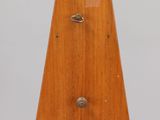 an image of a wooden clock sitting on top of a glass table