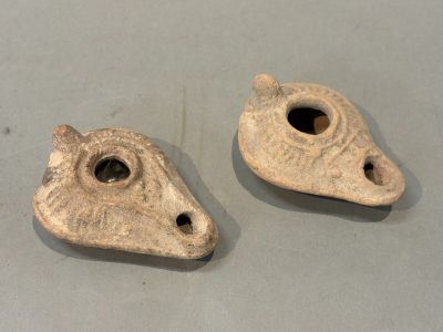 two pieces of clay with holes in them on a table