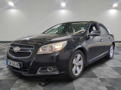 a picture of a black chevrolet malibu parked in a garage