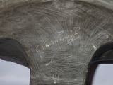 a close up of a metal object with writing on it