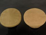pair of black and tan stools on a black background