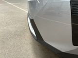 a close up of a car ' s tail light on the side of the road