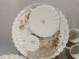 a lot of plates and cups sitting on a table