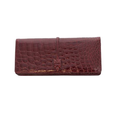 an image of a women ' s wallet with a red alligator skin pattern