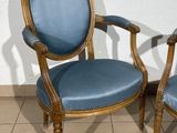 two blue chairs sitting next to each other on a tiled floor