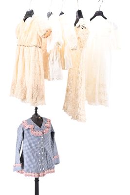 three mannequins with dresses hanging on a clothes rack