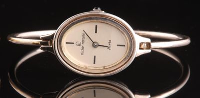 Michel HERBELIN. Montre de dame à boîtier et bracelet jonc en argent (
