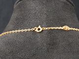 a close up of a mannequin with a gold chain on it
