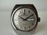a close up of a watch on a white surface