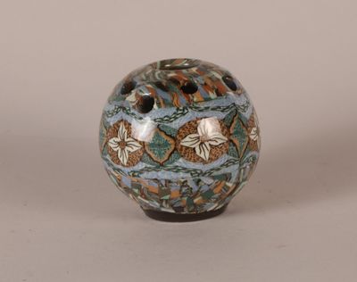 a blue vase with a design on it on a white surface