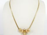 a gold necklace on a mannequin mannequin torso