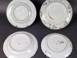 three plates with floral designs on them sitting on a table