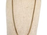a mannequin torso with a gold chain necklace on it